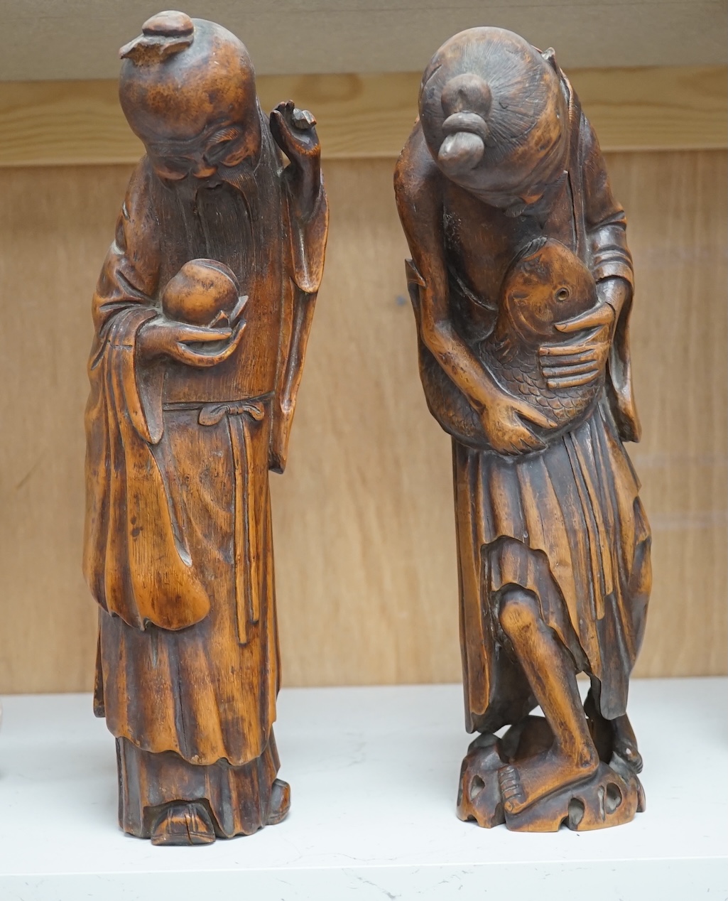 Two 19th century Chinese bamboo root figures of a fisherman and Shou Lao, tallest 32cm. Condition - fair to good